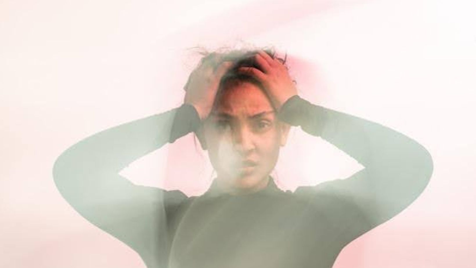 person holding their head